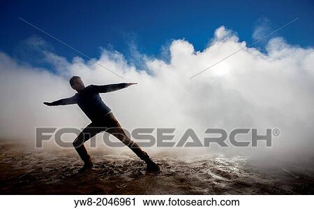 Stock Image - Man in the steam at Namaskard- Geothermal Volcanic area, Northern Iceland.. Fotosearch