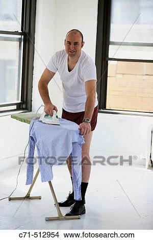 Man in underwear ironing his clothes. View Large Photo Image Picture - Man in underwear ironing his clothes.. Fotosearch