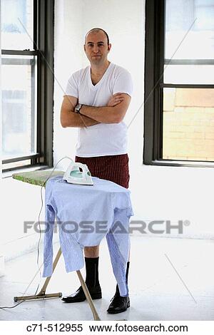 Man in underwear ironing his clothes. View Large Photo Image Stock Photography - Man in underwear ironing his clothes.. Fotosearch