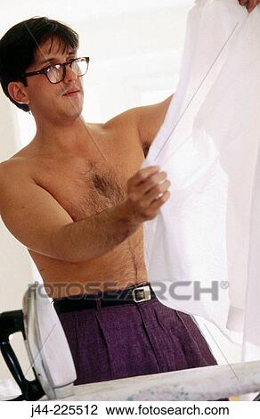 Man ironing shirt at home View Large Photo Image Stock Image - Man ironing shirt at home. Fotosearch