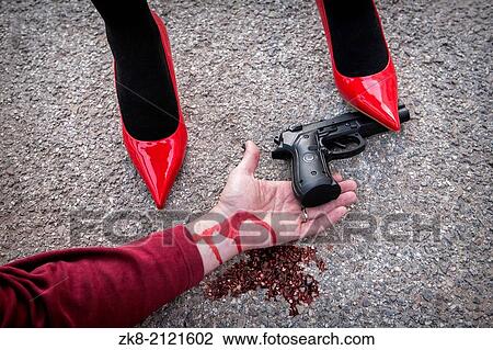 Man is dominated by a woman with red shoes, the shoe tread gun arm bloodied on the asphalt. View Large Photo Image Stock Image - Man is dominated by a woman with red shoes, the shoe tread gun arm bloodied on the asphalt.. Fotosearch