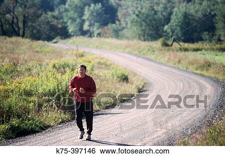 man jogging on country road View Large Photo Image Stock Photograph - man jogging on country road. Fotosearch