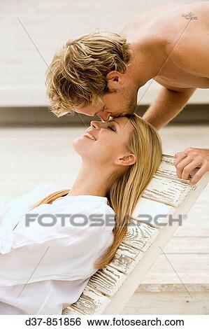Man kissing tenderly a woman on her forehead View Large Photo Image Stock Photograph - Man kissing tenderly a woman on her forehead. Fotosearch
