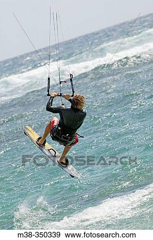Stock Photo - Man kiteboarding in Kauai. USA. Fotosearch
