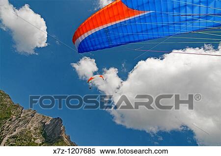 Man landing after paragliding at Le Brevent in the Aiguilles Rouges, high above the city of Chamonix, France View Large Photo Image Stock Photography - Man landing after paragliding at Le Brevent in the Aiguilles Rouges, high above the city of Chamonix, France. Fotosearch