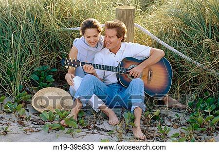 man laying guitar for his girlfriend View Large Photo Image Stock Image - man laying guitar for his girlfriend. Fotosearch