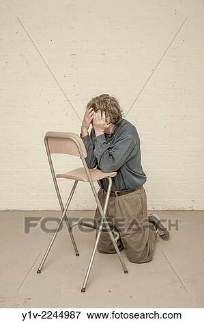 Man leaning on a chair. View Large Photo Image Stock Photo - Man leaning on a chair.. Fotosearch