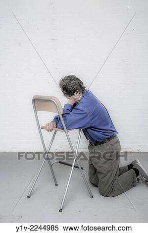 Man leaning on a chair. View Large Photo Image Stock Photography - Man leaning on a chair.. Fotosearch