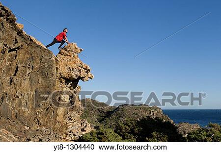 Man leaning on rocks at Cap de Creus in Catalonia, Spain View Large Photo Image Stock Image - Man leaning on rocks at Cap de Creus in Catalonia, Spain. Fotosearch
