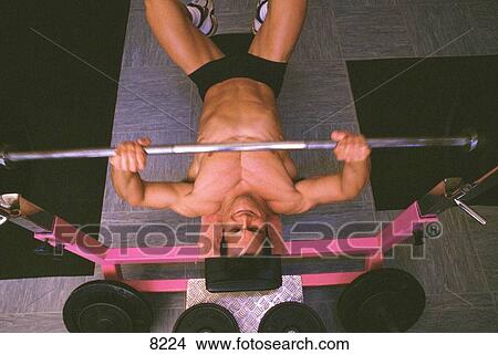 Picture - Man lifting weights. Fotosearch