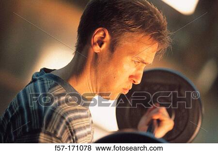 Stock Photo - Man lifting weights. Fotosearch