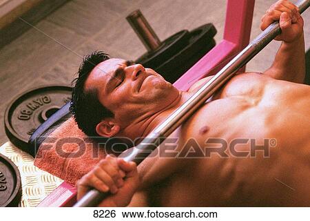 Stock Photograph - Man lifting weights. Fotosearch