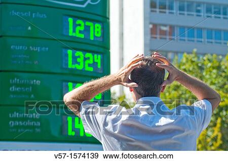 Man looking astonished at petrol prices View Large Photo Image Stock Photo - Man looking astonished at petrol prices. Fotosearch