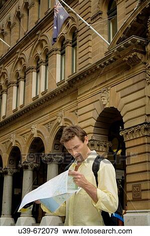 Man looking at a map in a city. Sydney. View Large Photo Image Stock Photo - Man looking at a map in a city. Sydney.. Fotosearch