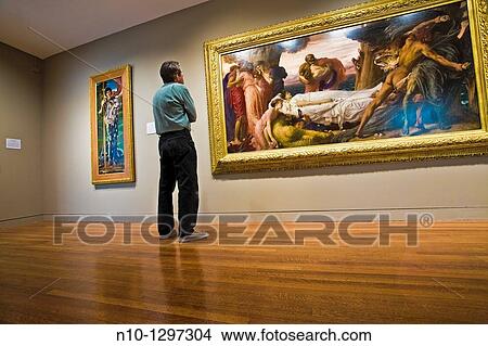 Man looking at a painting in the museum View Large Photo Image Picture - Man looking at a painting in the museum. Fotosearch