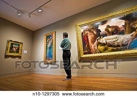 Man looking at a painting in the museum View Large Photo Image Stock Photography - Man looking at a painting in the museum. Fotosearch
