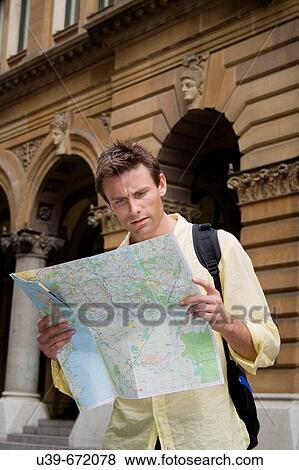Man looking at map in a city. View Large Photo Image Stock Photo - Man looking at map in a city.. Fotosearch