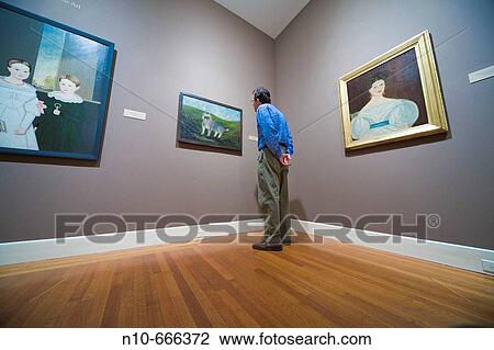 Man looking at paintings in a museum. View Large Photo Image Stock Image - Man looking at paintings in a museum.. Fotosearch