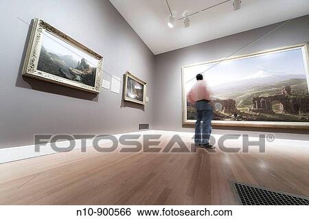 Man looking at paintings in a museum. View Large Photo Image Stock Photograph - Man looking at paintings in a museum.. Fotosearch