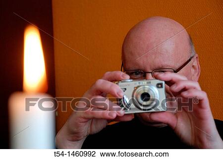 Man looking display of a digital camera View Large Photo Image Stock Image - Man looking display of a digital camera. Fotosearch
