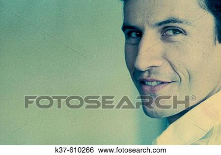 Man looking over shoulder with naughty smile View Large Photo Image Stock Photograph - Man looking over shoulder with naughty smile. Fotosearch