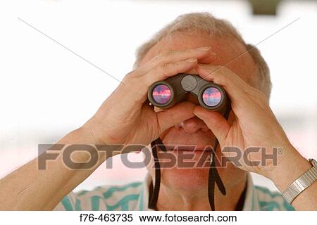 Man looking through binoculars View Large Photo Image Stock Photography - Man looking through binoculars. Fotosearch