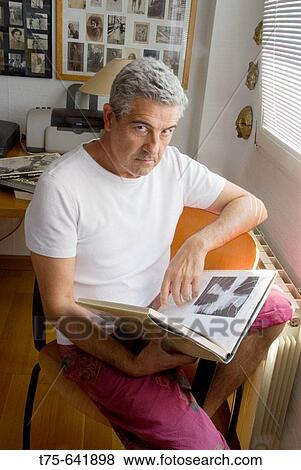 Man looking to photography book. View Large Photo Image Stock Photo - Man looking to photography book.. Fotosearch