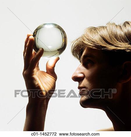 Man looking up into a crystal ball View Large Photo Image Stock Image - Man looking up into a crystal ball. Fotosearch