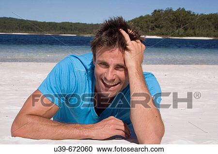Man lying on a beautiful beach, laughing. Fraser Island, Australia View Large Photo Image Stock Image - Man lying on a beautiful beach, laughing. Fraser Island, Australia. Fotosearch