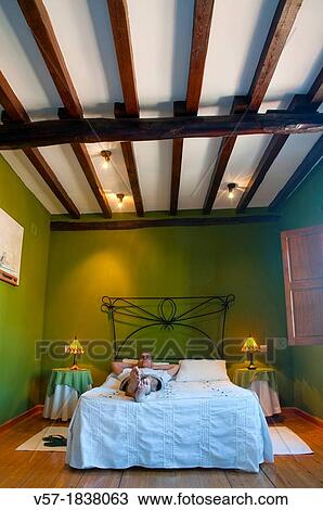 Man lying on bed in a rural hotel View Large Photo Image Stock Image - Man lying on bed in a rural hotel. Fotosearch