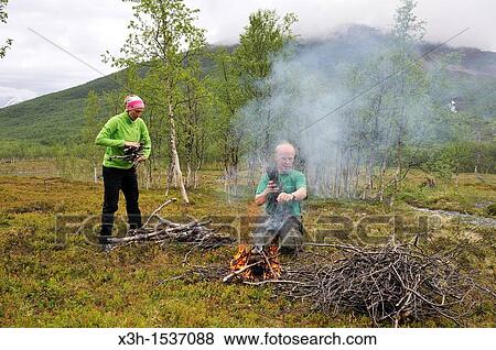 man making a campfire, Nordmannvikdalen valley, region of Lyngen, County of Troms, Norway, Northern Europe View Large Photo Image Stock Photo - man making a campfire, Nordmannvikdalen valley, region of Lyngen, County of Troms, Norway, Northern Europe. Fotosearch
