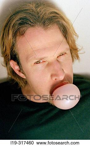 Man making a chewing gum bubble View Large Photo Image Stock Image - Man making a chewing gum bubble. Fotosearch