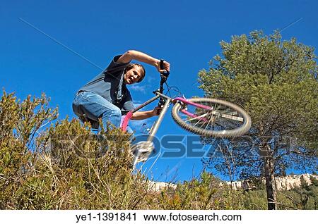 Man making jumps through bushes on his mountain bike, Vitrolles, Provence, France View Large Photo Image Stock Image - Man making jumps through bushes on his mountain bike, Vitrolles, Provence, France. Fotosearch