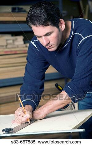 Man measuring a piece of wood with a straightedge View Large Photo Image Stock Photography - Man measuring a piece of wood with a straightedge. Fotosearch