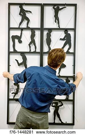 Man measuring artwork on wall View Large Photo Image Stock Image - Man measuring artwork on wall. Fotosearch