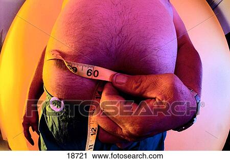 Man measuring his waist View Large Photo Image Stock Image - Man measuring his waist. Fotosearch