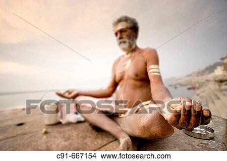 Man meditating by the Ganges, Varanasi. Uttar Pradesh, India View Large Photo Image Picture - Man meditating by the Ganges, Varanasi. Uttar Pradesh, India. Fotosearch
