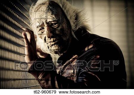 Stock Photo - Man monstrous face Mask Crazy Color. Fotosearch