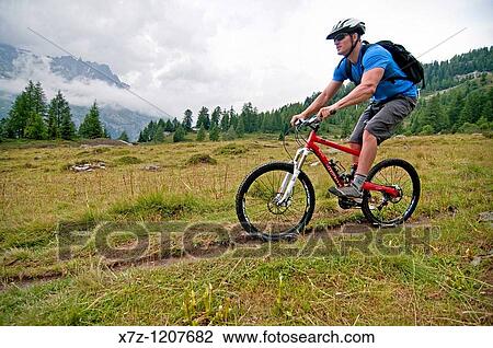 Man mountain biking at Les Grands Montets on Le Lavancher Trail above the towns of Argentiere and Chamonix France View Large Photo Image Stock Image - Man mountain biking at Les Grands Montets on Le Lavancher Trail above the towns of Argentiere and Chamonix France. Fotosearch