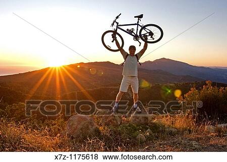 Man mountain biking at sunset in the Santa Ynez Mountains near the city of Santa Barbara in southern California USA View Large Photo Image Stock Photo - Man mountain biking at sunset in the Santa Ynez Mountains near the city of Santa Barbara in southern California USA. Fotosearch