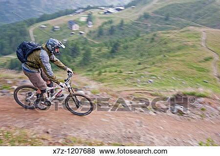 Man mountain biking from Gornergrat on the Mark Twain Trail near Riffelberg high in the Swiss Alps above the city of Zermatt Switzerland View Large Photo Image Stock Photo - Man mountain biking from Gornergrat on the Mark Twain Trail near Riffelberg high in the Swiss Alps above the city of Zermatt Switzerland. Fotosearch