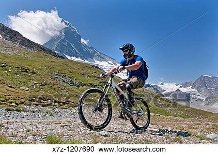 Man mountain biking the Matterhorn Trail below Schwarzsee Paradise in the Swiss Alps high above the town of Zermatt Switzerland View Large Photo Image Stock Image - Man mountain biking the Matterhorn Trail below Schwarzsee Paradise in the Swiss Alps high above the town of Zermatt Switzerland. Fotosearch