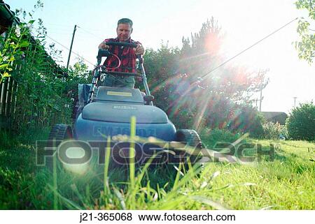 Stock Photo - Man mowing the lawn, garden. Bavaria, Germany. Fotosearch