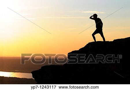 Stock Photo - Man observes Volga river from the highest point of Zhiguli mountains in Russian National Park? Samara Luka?. Fotosearch