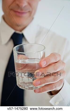Man offering a glass of water. Close view. View Large Photo Image Stock Image - Man offering a glass of water. Close view.. Fotosearch
