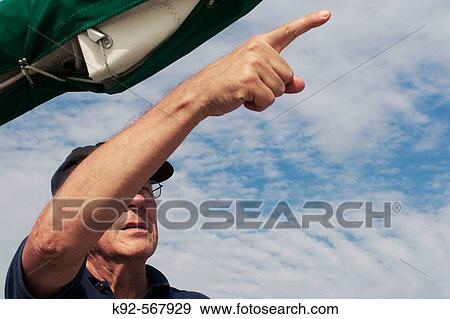 Man on a sailing boat pointing View Large Photo Image Stock Photo - Man on a sailing boat pointing. Fotosearch