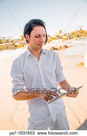 Man On Beach Using Ipad View Large Photo Image Stock Image - Man On Beach Using Ipad. Fotosearch