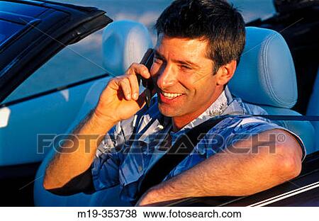 man on cellular in a convertible View Large Photo Image Stock Photo - man on cellular in a convertible. Fotosearch