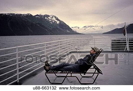Stock Image - Man on deck of boat, Alaska. Fotosearch