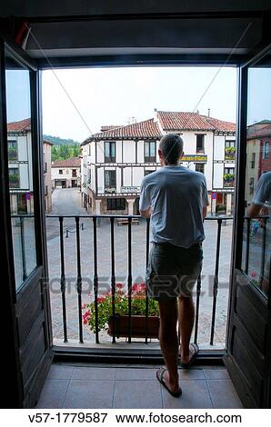 Stock Photo - Man on the balcony. Covarrubias, Burgos province, Castilla Leon, Spain.. Fotosearch